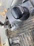 Close-up of the control lever of a 2012 John Deere 310SJ equipment with a textured grip and a base on the machinery floor