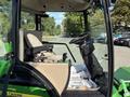 Interior view of a 2021 John Deere 1575 lawn tractor featuring a comfortable operator's seat and control panel with various buttons and levers for operation