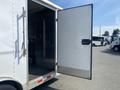 A 2008 Wells Industries Inc EW1422 delivery van with an open side door showing the interior storage space