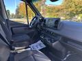 Interior view of a 2024 Mercedes-Benz Sprinter 2500 showing the driver's seat dashboard and center console with cup holders