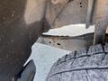 A 2016 Ford F-250 SD showing part of the frame and tire with dirt and debris visible