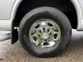 A chrome wheel rim with a Chevrolet logo on a Michelin tire mounted on a 2021 Chevrolet Express