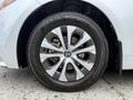 A close-up view of a silver alloy wheel with a Toyota emblem and an Avid GT tire on a 2025 Toyota Corolla