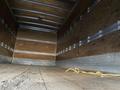 Interior of a 2014 International TerraStar truck with wooden walls and a wooden floor featuring a yellow power cord on the ground