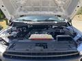 A 2019 Ford F-150 with its hood lifted displaying the engine compartment and various components including the battery and fluid reservoir