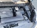 Close-up of a 2017 Nissan Murano engine featuring a V6 engine cover and various components including a battery and coolant reservoir