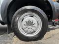 Close-up of a silver wheel and tire from a 2007 Ford F-450 showing the design of the rim and tire tread