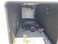 Interior of a 2021 Grand Design Recreational ST3478MBS showing empty storage space with a hose and control panels visible