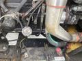 A close-up view of the engine compartment of a 2010 Vermeer Corporation BC1000XL with visible wiring hoses and components
