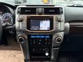 The interior dashboard of a 2018 Toyota 4Runner featuring a touchscreen display climate controls and various buttons and knobs