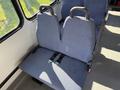 A pair of blue seats with seatbelts in a 2017 Chevrolet Express van interior