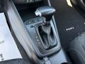 Close-up of the gear shift and console in a 2018 Kia Rio5 featuring buttons for driving modes and a manual gear lever
