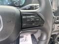 Steering wheel of a 2023 RAM Promaster 3500 featuring control buttons for cruise control including set and cancel functions