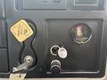 Dashboard of a 2013 International DuraStar 4300 showing a parking brake lever a filtered minder gauge and a key slot