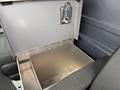 A silver metal storage compartment with a secure latch located in the cabin of a 2017 Mercedes-Benz Sprinter