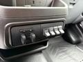 A control panel with knobs and four auxiliary buttons in a 2018 Ford Transit vehicle interior