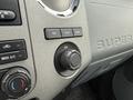 The image shows the dashboard controls of a 2011 Ford F-650 featuring knobs for climate control and settings along with a textured surface labeled SUPER