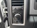 Control panel of a 2016 RAM 1500 featuring knobs and buttons for adjusting headlights and dashboard brightness