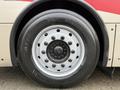 Close-up of a wheel on a 2016 Grande West Vicinity bus featuring a silver rim and black tire with tread markings