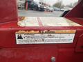 A close-up of a red warning label on a 2017 Ferris Rotary mower indicating fire hazard and safety instructions regarding gasoline and debris