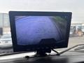 Monitor displaying a rearview camera feed showing a paved road ahead