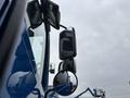 A blue 2017 Autocar Xpert truck with multiple side mirrors reflecting its surroundings