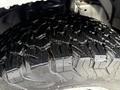Close-up of a rugged tire on a 2017 Ford F-350 SD showing deep treads designed for off-road and heavy-duty performance