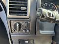 Dashboard controls of a 2011 Chevrolet Colorado including headlight switch and air vent with gauges visible in the background