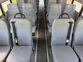 Interior of a 2009 International 3000 CE school bus featuring gray plastic seated rows with seatbelts and a central aisle