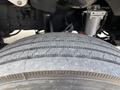 A close-up view of a tire on a 2010 Freightliner M2 106 showing tread patterns and rubber details
