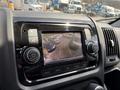 Dashboard of a 2021 RAM Promaster showing a rearview camera display with guidelines and a view of parked vehicles