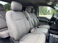 A 2018 Ford F-150 interior featuring gray cloth seats with seat belts and no occupants
