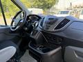 Interior view of a 2015 Ford Transit showing the dashboard and center console with controls and storage compartments