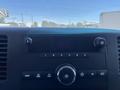 Dashboard of a 2013 Chevrolet Silverado 1500 featuring knobs and buttons for audio control and a digital display
