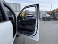 A 2021 Ford F-150 with the driver's door open showcasing the interior door panel and handle