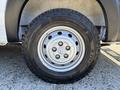 A close-up view of a 2020 RAM ProMaster 3500 front wheel and tire showing the five-spoke silver rim and all-terrain tire tread