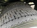 A close-up view of a worn tire on a 2020 Ford F-550 showing visible tread patterns and dirt accumulation