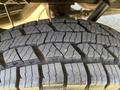 Close-up of a tread pattern on a tire from a 2024 Mercedes-Benz Sprinter 2500 showcasing deep grooves and robust design for traction