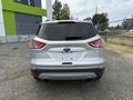A 2015 Ford Escape parked with a silver exterior and a rear view showing the back lights and logo