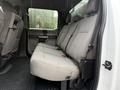 A 2020 Ford F-550 with a spacious rear seating area featuring gray fabric seats and a rubber floor mat