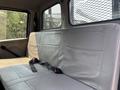 Interior of a 2006 Sterling Acterra showing the back seat with light gray upholstery and seatbelts