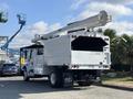A white 2019 Freightliner M2 106 utility truck with a raised hydraulic boom and a large storage compartment in the back