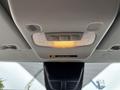 Interior overhead console of a 2020 Ford Transit 250 featuring lights and buttons for passenger safety and controls