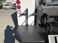 A 2005 Freightliner M2 106 featuring a textured black platform with mounting brackets and rear lights