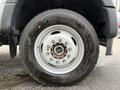 Close-up of a white wheel and tire from a 2022 Ford F600 showcasing a five-bolt pattern and visible tread on the tire