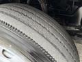 A worn tire from a 2009 UD Trucks UD 3300 showing visible tread patterns and cracks on the surface
