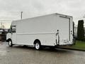 A white 2018 Ford E-450 box truck with a large cargo area and no visible branding is parked with its back facing the viewer