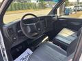 The interior of a 2005 GMC C7500 Topkick featuring a steering wheel vinyl seats and control dashboard with various buttons and dials