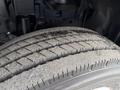 Close-up of a well-used tire from a 2014 Hino 195 showing distinct tread patterns and some dirt on the surface