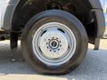 Close-up of a 2019 Ford F-550 wheel showcasing a silver rim with multiple bolts and a black tire with tread design